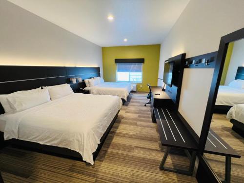 a hotel room with two beds and a television at Holiday Inn Express & Suites Salinas by IHG in Salinas
