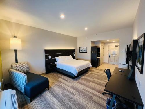 a large hotel room with a bed and a desk at Holiday Inn Express & Suites Salinas, an IHG Hotel in Salinas