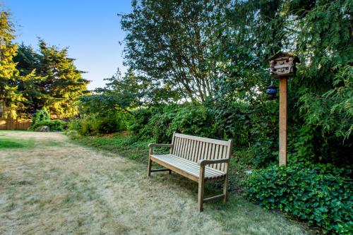 a wooden bench next to a bird house at Evergreen at Semiahmoo in Blaine