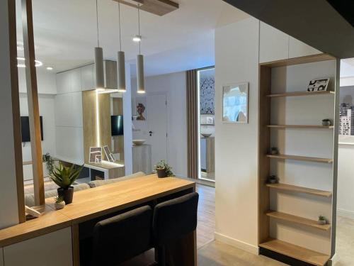 a kitchen with a wooden counter with two chairs at Palas Loft in Iaşi