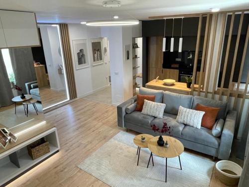 a living room with a couch and a table at Palas Loft in Iaşi