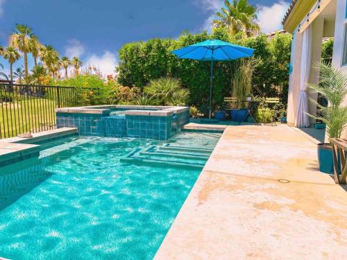 a swimming pool with an umbrella in a yard at Entire Bungalow w/ Private Pool Near Palm Springs! in Indio