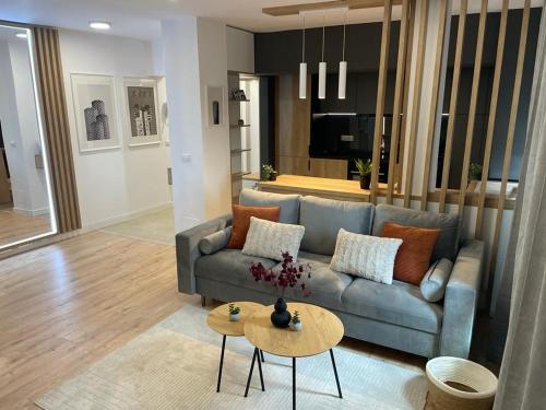 a living room with a couch and a table at Palas Loft in Iaşi