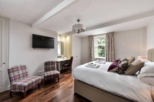 a bedroom with a bed and a desk and a television at 30 Lade Braes in St. Andrews