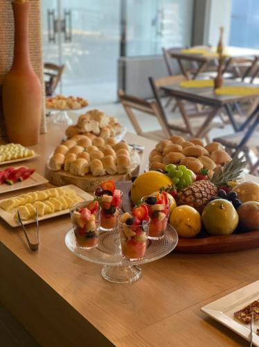 a table topped with lots of different types of food at Porto de Galinhas PORTO EXCLUSIVE BY AFT in Porto De Galinhas