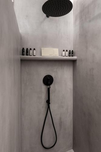 a room with a shelf with a black lamp at Manesis Suites in Pollonia