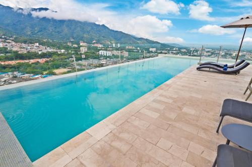 a swimming pool with a view of the mountains at Sonesta Hotel Ibagué in Ibagué
