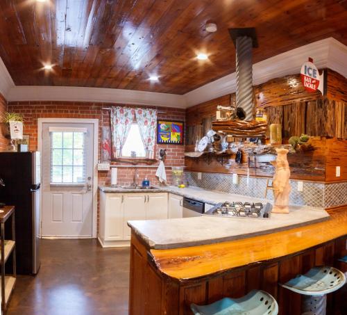 a kitchen with wooden walls and a wooden ceiling at Bayou Chateau in New Iberia