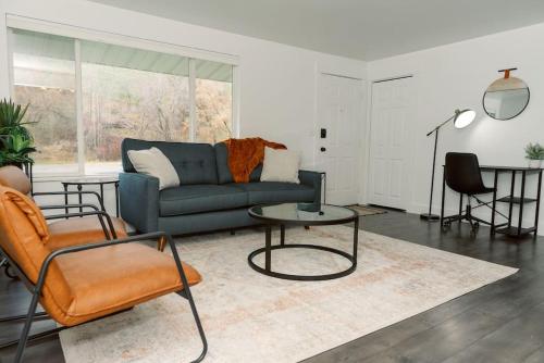 a living room with a couch and a table and chairs at Cheerful 3 Bedroom near USU - Inspiring Memories in Logan