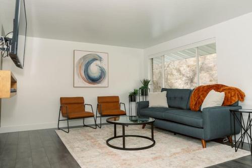 a living room with a blue couch and two chairs at Cheerful 3 Bedroom near USU - Inspiring Memories in Logan