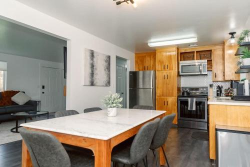 a kitchen and dining room with a table and chairs at Cheerful 3 Bedroom near USU - Inspiring Memories in Logan