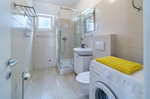 a bathroom with a toilet sink and a shower at ameli in Milna