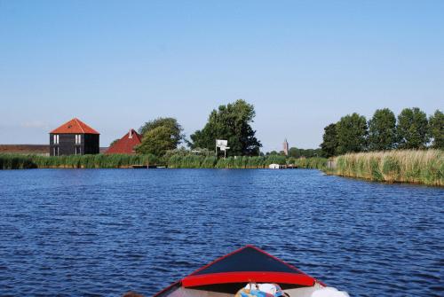 a person in a boat on a body of water at Hoeve Meerzicht in Monnickendam
