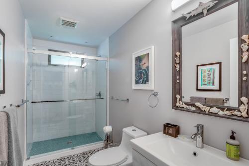 a bathroom with a shower and a toilet and a sink at Bonita Springs Landing in Bonita Springs