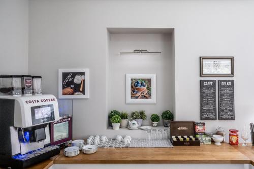 a coffee shop with a counter with a coffee machine at Hotel Europejski in Nysa