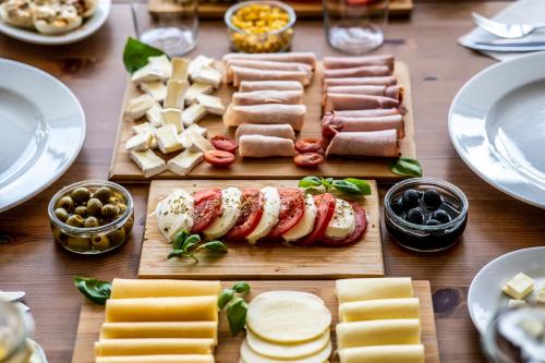 a table topped with cheese and meats and other appetizers at Hotel Europejski in Nysa