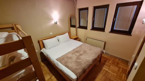 a small room with a bed and two bunk beds at Apartment Kristi in Kruševo