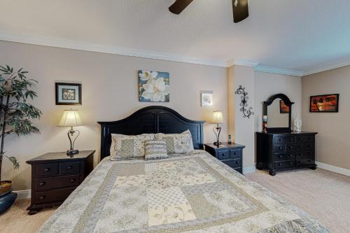 a bedroom with a large bed and two night stands at Paradise Shores 105 in Mexico Beach