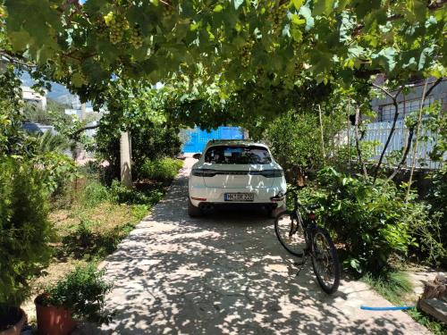 a car parked on the side of a road with a bike at Magic Ionian Apartments & Rooms in Himare