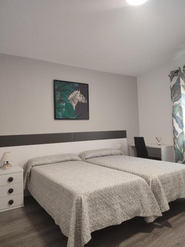 a white bedroom with a bed and a chair at Casa Luzon, terraza-solarium con ducha y salon rustico in Villarejo de Salvanés