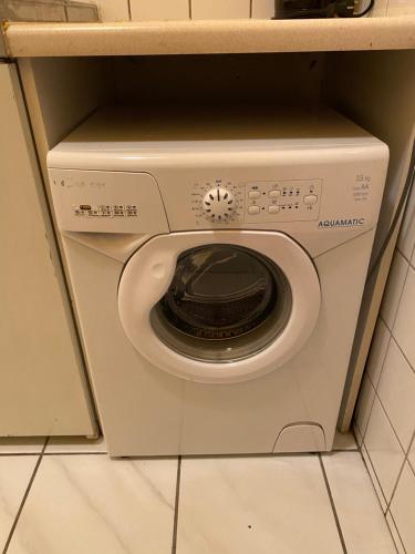 a white washing machine in a corner of a kitchen at Appartement Pension 700m zum Ring in Vienna