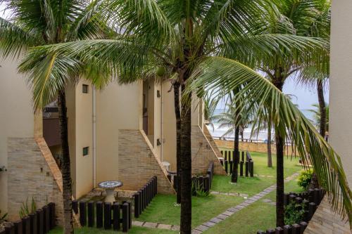 a palm tree in front of a building with a staircase at Beira Mar Salvador Bahia Brazil climatizado in Salvador