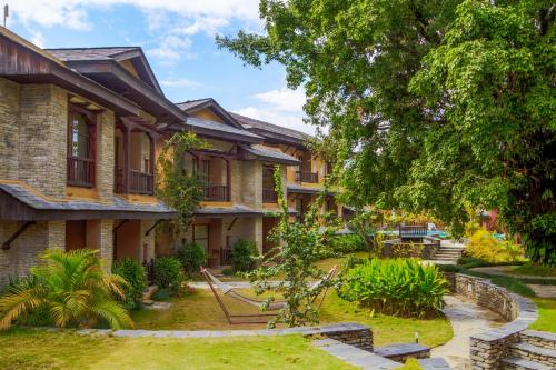 a house with a garden in front of it at Temple Tree Resort & Spa, Pokhara in Pokhara