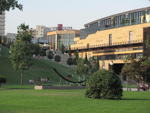 a group of people in a park in front of a building at Hotel Ceramica in Iaşi