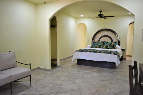 a bedroom with a bed and a ceiling fan at HACIENDA MONARCAS Resort in Puerto Peñasco