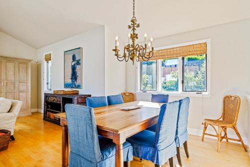 a dining room with a wooden table and blue chairs at Golden Getaway in Summerland