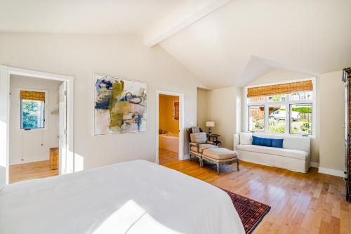a bedroom with a bed and a living room at Golden Getaway in Summerland