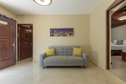 a blue couch in a room with a bedroom at Hotel Turístico Marian in Las Terrenas