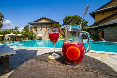 a drink in a pitcher and a wine glass on a table at Temple Tree Resort & Spa, Pokhara in Pokhara