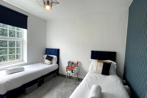 a bedroom with two beds and a window at Luxury 2 Bed Duplex Apartment by YO ROOM! - Leicester City- Free Parking in Leicester