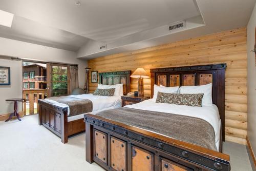 two beds in a bedroom with wooden walls at The Lodges at Deer Valley-B - #5325 in Park City