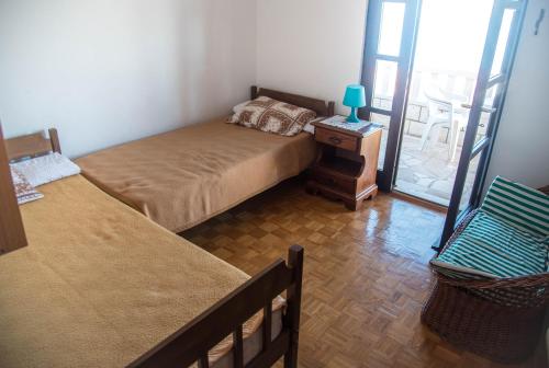 a bedroom with two beds and a table with a lamp at Apartments with a parking space Postira, Brac - 6049 in Postira