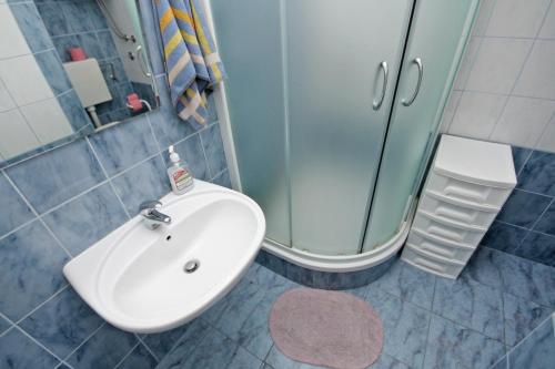 a bathroom with a sink and a shower at Apartments with a parking space Omis - 5988 in Omiš
