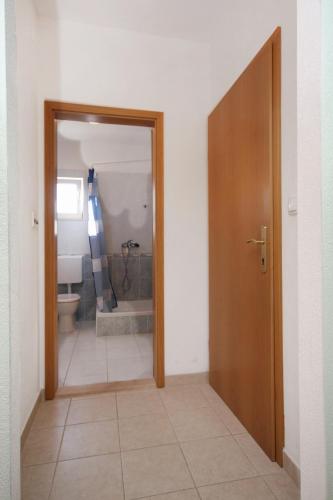 a hallway with a bathroom with a toilet and a door at Apartments with parking space Slatine, Ciovo - 5999 in Slatine