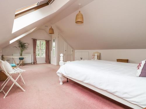 a bedroom with a large white bed and a window at Bolitho's Retreat in Saint Martins Green