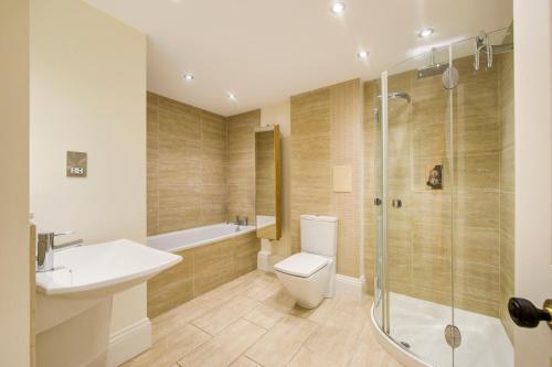 a bathroom with a toilet and a sink and a shower at Super central Edinburgh Castle basement in Edinburgh