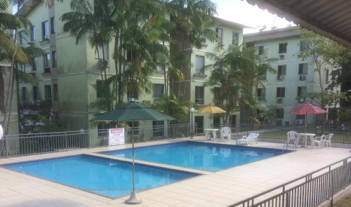 a swimming pool in front of a building at Apartamento "Executivo de Luxo" in Belém