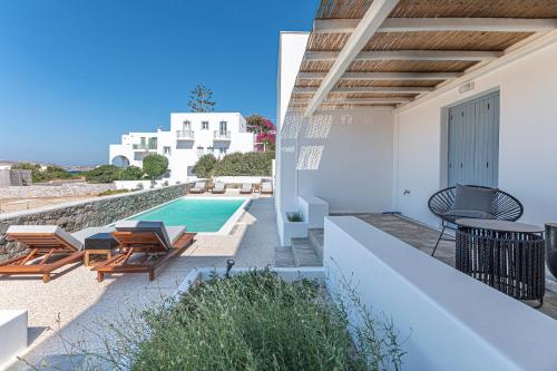 a view from the balcony of a villa with a swimming pool at Manesis Suites in Pollonia
