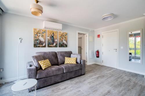 a living room with a couch and a table at Mar Apartments Alicante, Playa de San Juan in Alicante