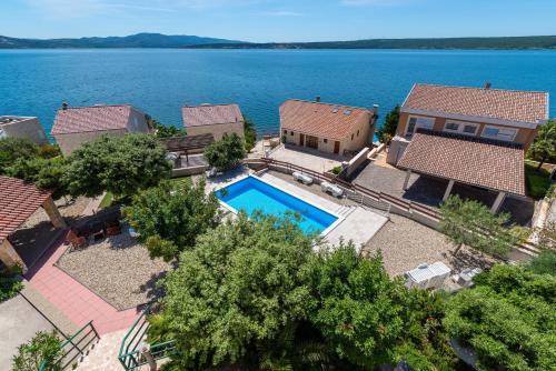 an aerial view of a house with a swimming pool at Seaside apartments with a swimming pool Posedarje, Novigrad - 6162 in Posedarje