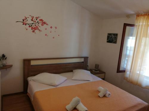 a bedroom with a bed with two towels on it at Apartments by the sea Nin, Zadar - 6125 in Nin