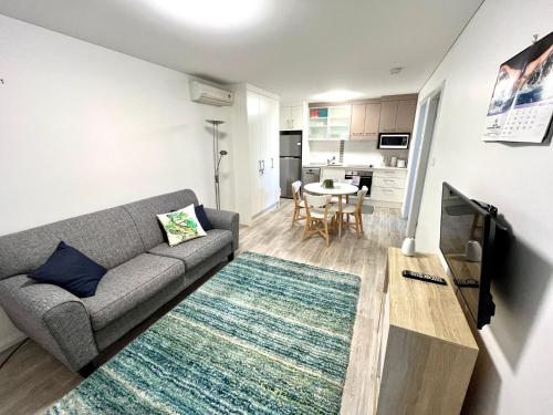 a living room with a couch and a table at H2O Holiday Apartments - Unit 4 in North Haven