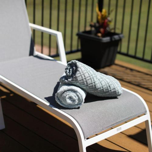 a pillow sitting on a chair on a deck at Skippers at Dundee in Dundee Beach