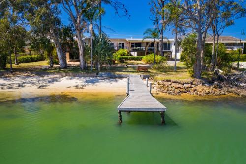 a wooden dock in the middle of a body of water at H2O Holiday Apartments - Unit 4 in North Haven
