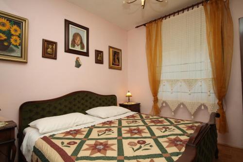 a bedroom with a bed with a quilt on it at Apartments with parking space Rabac, Labin - 7465 in Rabac