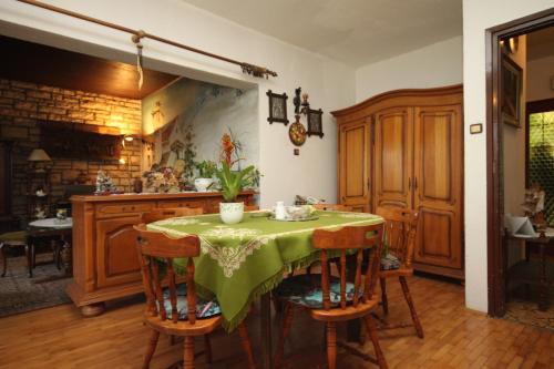 a kitchen with a table with a green table cloth at Apartments with parking space Rabac, Labin - 7465 in Rabac